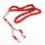 Islamic coral prayer necklace with unmarked silver coloured metal mounts, 30cm in length, 29.0g :