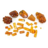 Loose amber coloured fragments and brooches, the largest 5.5cm in length, 70.0g : For Further
