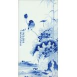 Chinese blue and white panel housed in a carved hardwood frame, hand painted with a bird on a rock