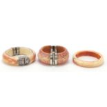 Three tribal interest ivory bangles with applied silver mounts, 10cm in diameter : For Further