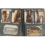 Edwardian and later postcards arranged in an album including Margaret Tarrant, Mabel Lucy Attwell,