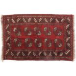 Rectangular Persian rug having a geometric design onto a red ground, 113cm x 74cm : For Further