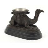 Bronze model of a crouching camel raised on oval stepped base, 28cm in length : For Further