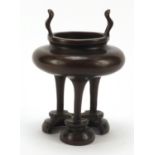 Chinese patinated bronze tripod censer with twin handles, character marks to the base, 17cm high :