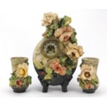 19th century French floral encrusted pottery mantle clock with garniture vases by Henri Marc of