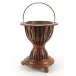 Regency style inlaid mahogany ice bucket with brass liner and swing handle, 41cm high : For