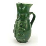 Green glazed jug modelled as a soldier, 24cm high : For Further Condition Reports Please Visit Our