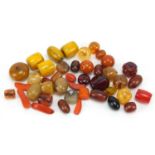 Loose amber coloured beads, the largest 3.5cm in length, 315.0g : For Further Condition Reports