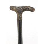 Ebonised walking stick with silver handle having floral and 'C' scroll embossed decoration, 80cm