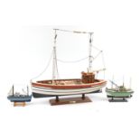 Large wooden model boat and two smaller examples, the largest 60cm in length : For Further Condition