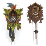 Two Black Forest cuckoo clocks including one carved with birds, the largest 30cm high : For