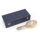 Silver backed clothes brush by WI Broadway & Co, embossed with face masks, birds and foliage,