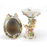 19th century floral encrusted Dresden porcelain centrepiece and mirror, each mounted with cherubs,