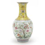 Chinese porcelain bottle vase, hand painted in the famille rose palette with flowers and a garden
