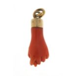 Victorian carved coral pendant in the form of a clutched hand with unmarked gold mount, 2.5cm in