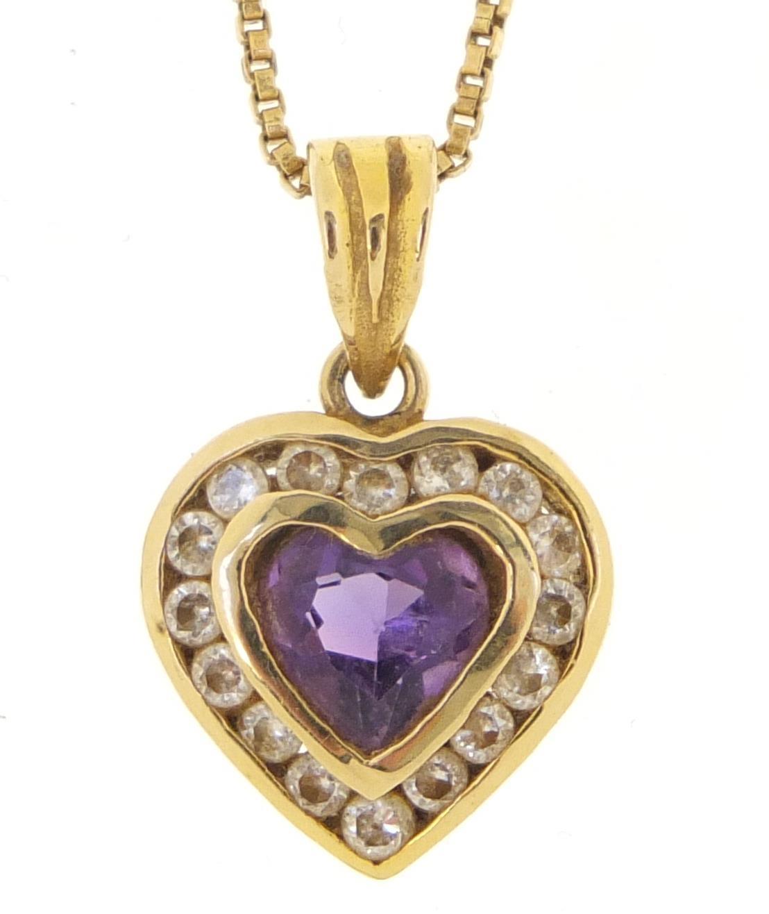 14ct gold amethyst and clear stone love heart pendant, 2cm in length on an unmarked gold coloured
