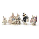 Dresden, four German porcelain lace figurines including a group of a couple playing chess, the