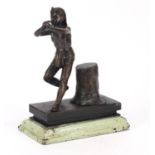 Bronzed Indian boy beside a trunk raised on a painted wooden base, 21cm high