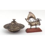 Egyptian unmarked silver muffin dish and cover and a silver model of a dhow boat, the dish 10.5cm in