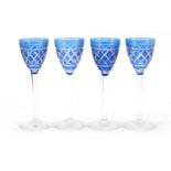 Four Bohemian blue overlaid cut sherry glasses, each 13.5cm high