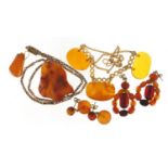 Amber coloured jewellery with gold coloured metal mounts, comprising two necklaces, two pairs of