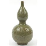 Korean stoneware double gourd vase having a celadon glaze, incised with floral motifs, 33.5cm high