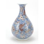 Chinese blue and white porcelain vase with iron red, hand painted with fish amongst waves and