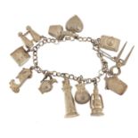 Silver charm bracelet with a selection of silver coloured metal charms including lighthouse,