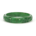 Chinese green jade bangle carved with flowers, 7.5cm in diameter