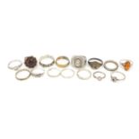 Fifteen silver and white metal rings, some with semi precious stones including amber and garnet,