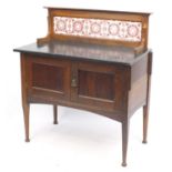 Oak washstand with Art Nouveau design tile back and black granite top, 103cm H x 91cm W x 48cm D