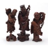 Three Chinese root wood carvings of Elders, the largest 36cm high