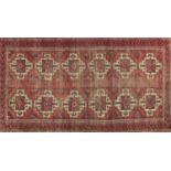 Rectangular Persian rug having a geometric repeat central field on to red grounds, 190cm x 99cm