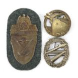 Two German military interest badges and a Demjansk arm patch including a Blockade runner badge