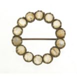 Silver cabochon moonstone brooch, 2.6cm in diameter, 4.0g