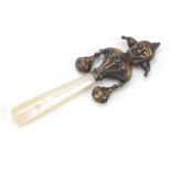 Mother of pearl and brass Joker design baby rattle, 9.5cm in length