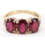 9ct gold ruby trilogy ring with diamond set shoulders, size O/P, 3.0g