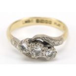 18ct gold diamond three stone crossover ring, size J, 3.0g