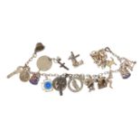 Two silver charm bracelets with mostly silver charms including vintage telephone, harp, policeman'