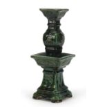 Large Chinese archaic style candlestick having a green glaze, 38cm high