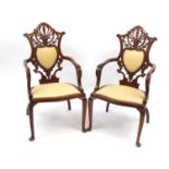 Pair of carved walnut salon chairs with shield backs, each 104cm high