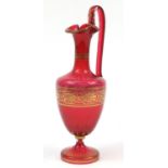 19th century cranberry glass encaustic ewer with gilded decoration, 37cm high
