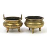 Two Chinese engraved bronze tripod censers including one with twin handles, each with character