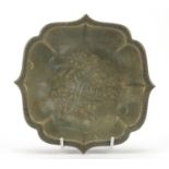 Chinese porcelain flower head dish having a celadon glaze, decorated in low relief with flowers,