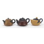 Three Chinese Yixing terracotta teapots including one in the form of a peach and a marbleised