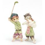 Two Continental comical porcelain cats including a golfer, the largest 26cm high