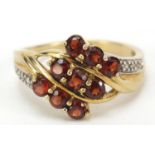 9ct gold red stone crossover ring with diamond shoulders, size O, 2.9g