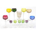 Eleven Bohemian flashed cut glass wine glasses and a Turkish gilded cup, the largest 19cm high