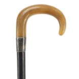 Ebonised walking stick with rhinoceros horn handle, 90cm in length