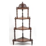 Victorian walnut four tier whatnot with serpentine front, 137cm high